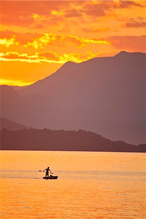 Brazil, Rio de Janeiro State, Angra dos Reis, Ilha Grande, a fisherman silhouetted against the sunset over the Costa Verde, Green Coast, Stock Photo - Rights-Managed, Code: 862-06675710