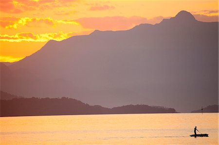 picture of a person on a tropical island - Brazil, Rio de Janeiro State, Angra dos Reis, Ilha Grande, a fisherman silhouetted against the sunset over the Costa Verde, Green Coast, Stock Photo - Rights-Managed, Code: 862-06675711