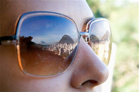 slum - South America, Rio de Janeiro, Rio de Janeiro city, view of breeze block houses in the Dona Marta favela, Santa Marta community, the Dois Irmaos mountains and the Lagoa Rodrigo de Freitas in a womans sunglasses Stock Photo - Rights-Managed, Code: 862-06675810