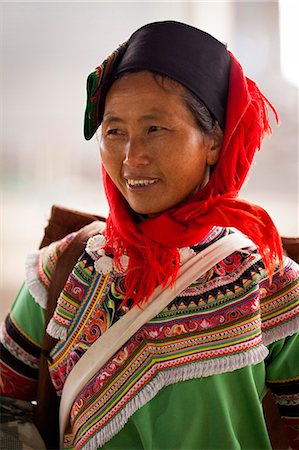 protector - China, Yunnan, Xinjie. A lady from the Hani ethnic minority group at Xinjie market, with a woven rush rain protector strapped to her back. Stock Photo - Rights-Managed, Code: 862-06676297