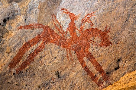 Chad, Guili Dweli, Ennedi, Sahara. A painting of a horse and rider possibly carrying a bow and lance decorates the sandstone wall of a cave. Stock Photo - Rights-Managed, Code: 862-06676440
