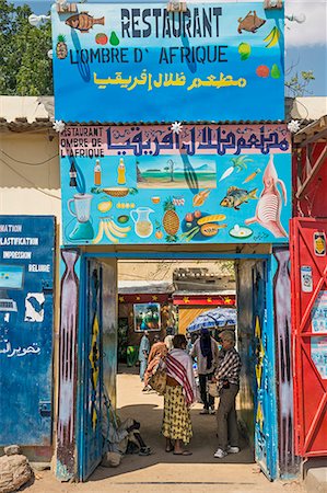 shops africa - Chad, Abeche, Ouaddai, Sahel.  Tourists at the small restaurant L Ombre D Africque in Abeche, Chad s fourth largest city. Stock Photo - Rights-Managed, Code: 862-06676540