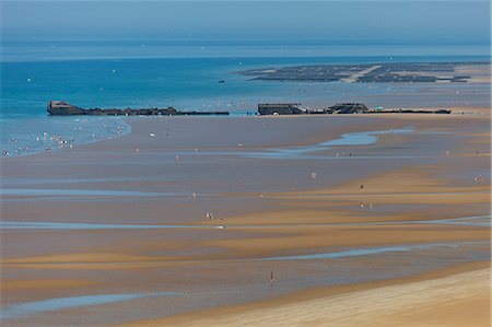 simsearch:862-06676770,k - Remnants of the D Day British controlled Mulberry Harbour System lie littered across Gold Beach at Arromanches les Bains, Basse Normandie, France Stock Photo - Rights-Managed, Code: 862-06676786