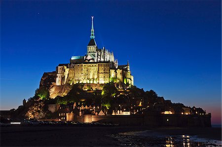 simsearch:862-06676770,k - Mont Saint Michel and its connection to the mainland via a tidal causeway at low tide by twilight, Le Mont Saint Michel, Basse Normandie, France. Stock Photo - Rights-Managed, Code: 862-06676788