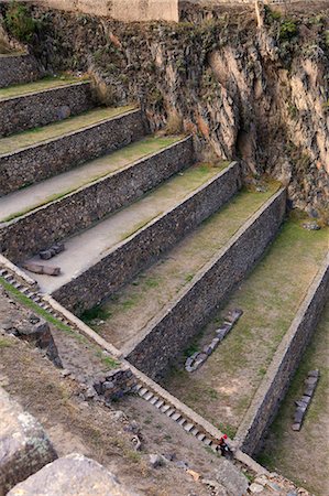 simsearch:862-06677365,k - South America, Peru, Cusco, Sacred Valley, Ollantaytambo. A tourist walks down a staircase past a series of terraces at the Inca ruins Stock Photo - Rights-Managed, Code: 862-06677345