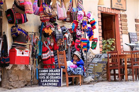 simsearch:862-06677365,k - South America, Peru, Cusco, Sacred Valley, Ollantaytambo. A Quechua girl mending a garment outside a tourist shop selling woolen clothing in Ollantaytambo village Stock Photo - Rights-Managed, Code: 862-06677352