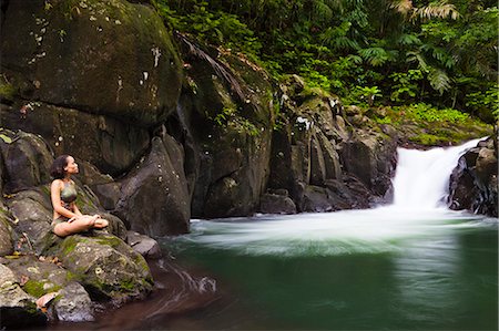 rainforest people - Dominica, Bense. A young woman sits on the rocks by La Chaudiere Pool. (MR). Stock Photo - Rights-Managed, Code: 862-06825225