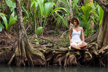 picture of a person on a tropical island - Dominica, Portsmouth. A young woman sits by the Indian River, one of Dominica's most popular tourist attractions. (MR). Stock Photo - Rights-Managed, Code: 862-06825259
