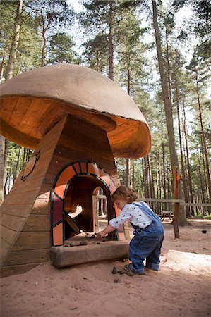 playhouse (children's toy) - Nottinghamshire, UK. Young child playing at Sherwood Pines forest park. (MR) Stock Photo - Rights-Managed, Code: 862-06825334