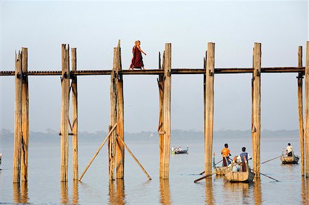 Myanmar, Burma, Mandalay Region, Mandalay. Monks stroll across the celebrated teak-built U Bein's Bridge which crosses  Taungthaman Lake near Mandalay. Stock Photo - Rights-Managed, Code: 862-06826098