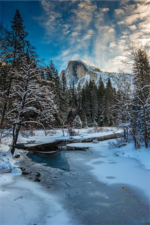 snow mountain trees river - Winter view over icy Tenaya creek with Half Dome mountain behind, Yosemite National Park, California, USA Stock Photo - Rights-Managed, Code: 862-07690958