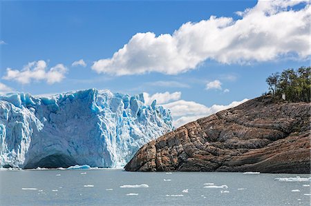 Argentina, Perito Moreno Glacier, Los Glaciares National Park, Santa Cruz Province.  A section of the glacier' s 74 m high wall with a glacial cave. Periodically pressure from its relentless advance against the headland dams the lake. Stock Photo - Rights-Managed, Code: 862-08089924