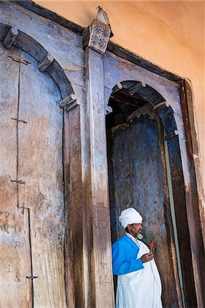 simsearch:862-03353978,k - Ethiopia, Abraha Atsbeha, Tigray Region. A Coptic priest outside the huge wooden doors of the semi monolithic 10th century church of Abraha Atsbeha. Stock Photo - Rights-Managed, Code: 862-08273069