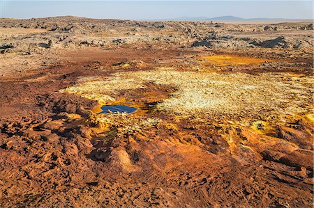 Ethiopia, Dallol, Afar Region. At almost 300 feet below sea level, Dallol is one of the lowest places on earth. Gas vents, geysers, salt, iron stains, sulphur and halophile algae turn the hot springs into a kaleidoscope spectacular colours. Stock Photo - Rights-Managed, Code: 862-08273089