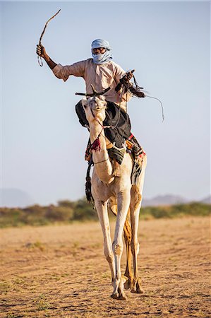 simsearch:862-03437232,k - Niger, Agadez, Iferouane. A Tuareg races his camel sitting on a traditional camel saddle. Stock Photo - Rights-Managed, Code: 862-08704976