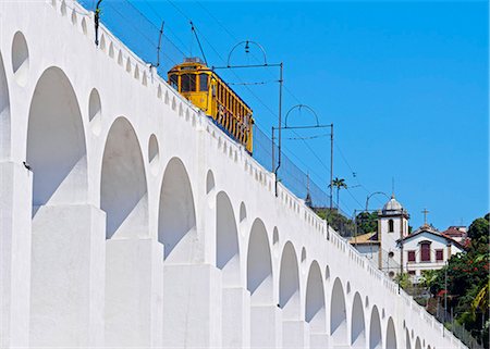 Brazil, State of Rio de Janeiro, City of Rio de Janeiro, Lapa, Tram crossing the Carioca Aqueduct and Convento de Santa Teresa. Stock Photo - Rights-Managed, Code: 862-08718464