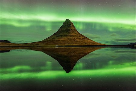 Grundafjordur, Snaefellsness peninsula, Western Iceland. Kirkjufell mountain reflecting in the waters of the lake with the northern lights (aurora borealis) in the background. Stock Photo - Rights-Managed, Code: 862-08718965