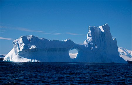 Weathered iceberg with a circular window near Booth Island. Stock Photo - Rights-Managed, Code: 862-03288452