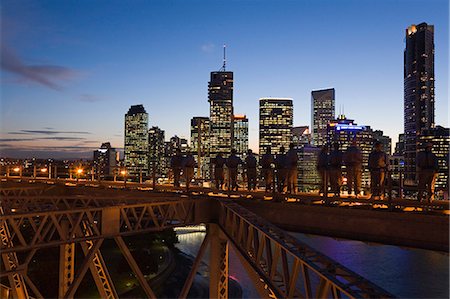 A group of climbers on Brisbane's Story Bridge are silhouetted against the illuminated city skyline. The Story Bridge Adventure Climb opened in 2005 and is one of only four such experiences in the world. Stock Photo - Rights-Managed, Code: 862-03288664