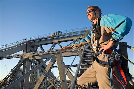 A Story Bridge Adventure Climb leader stands at the base of a bridge anchor arm. The Story Bridge is one of Brisbane's iconic sights and the climb is one of only four such experiences in the world. Stock Photo - Rights-Managed, Code: 862-03288662