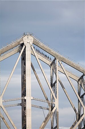 Climbers traverse the steel girders of the Story Bridge in Brisbane. The Story Bridge Adventure Climb on Brisbane's iconic structure is one of only four such experiences in the world. Stock Photo - Rights-Managed, Code: 862-03288672
