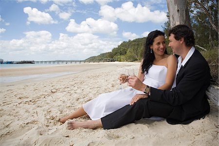 A couple enjoy a celebratory drink on the beach at Kingfisher Bay on Fraser Island. Stock Photo - Rights-Managed, Code: 862-03288753