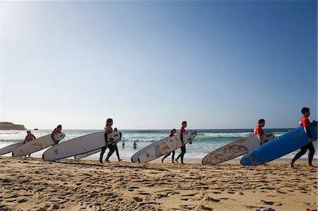 Surf school students carry their boards along Bondi Beach for a morning lesson Stock Photo - Rights-Managed, Code: 862-03288857