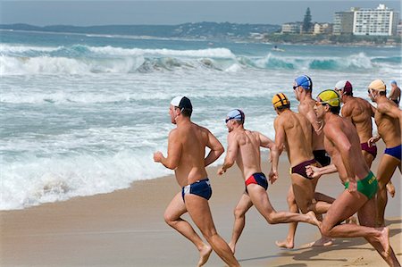 saver - Lifesavers wearing the colours of their respective clubs sprint to the water during a swimming race at the New South Wales Lifesaving Championships at Cronulla Beach. Stock Photo - Rights-Managed, Code: 862-03288868