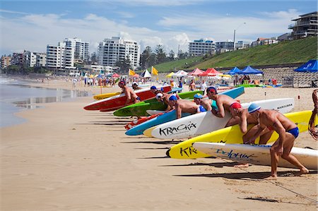 saver - Competitors line up for the start of a rescue board race on Cronulla Beach. The lifesavers in their respective club colours are competing in the New South Wales Life Saving Championships. Stock Photo - Rights-Managed, Code: 862-03288869