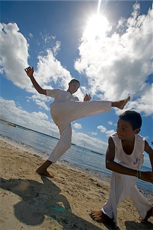 salvador - Capoeira,the Brazilian fight-dancing martial art,demonstrated on a Tinhare archipelago beach in the Bahia region,north east of Brazil Stock Photo - Rights-Managed, Code: 862-03289692
