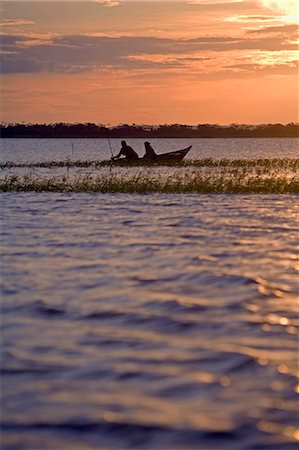 simsearch:862-03360742,k - Brazil,Amazon,Rio Tapajos. A tributary of the Rio Tapajos which is itself a tributary of the Amazon. Sunset on the river and some fishermen take in the last catch. Stock Photo - Rights-Managed, Code: 862-03289735