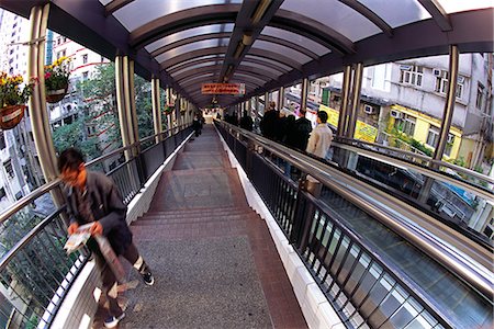 The Central Mid Levels Escalator system. The walkway and escalator system transports fifty thousand people a day up and down the steep streets of Hong Kong Island. Stock Photo - Rights-Managed, Code: 862-03289928