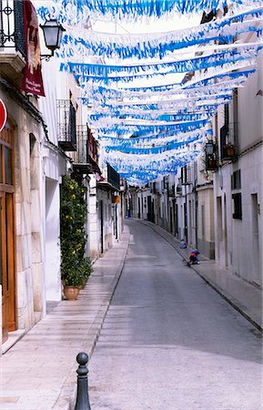 Bunting and flags are stretched across a street in preparation for a fiesta Stock Photo - Rights-Managed, Code: 862-03354232