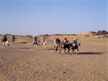 sudan - Children ride to school on donkeys along the edge of the Northern or Libyan Desert in northwest Sudan. Stock Photo - Rights-Managed, Code: 862-03354626