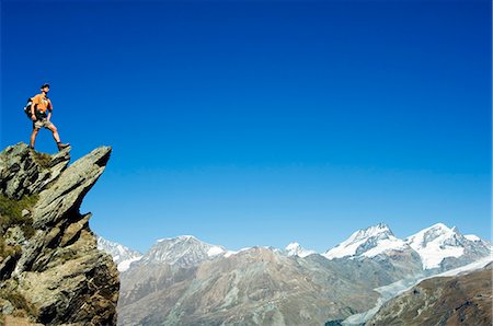 Hiker high on trail above snow capped mountains,Zermatt,Valais,Switzerland Stock Photo - Rights-Managed, Code: 862-03354725
