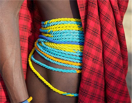 simsearch:862-03821033,k - A Datoga man with traditional strands of twisted beads round his waist. Yellow and light blue are the preferred colours of the beads worn by both men and women. The Datoga (known to their Maasai neighbours as the Mang'ati and to the Iraqw as Babaraig) live in northern Tanzania and are primarily pastoralists. Stock Photo - Rights-Managed, Code: 862-03355232