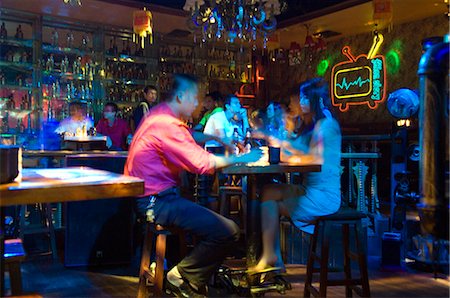 China,Hainan Province,Hainan Island,Sanya City. Chinese couple drinking in a nightclub. Stock Photo - Rights-Managed, Code: 862-03351199