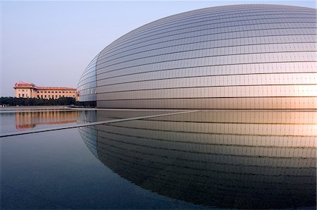 China,Beijing. The soviet style Great Hall of the People contrast with The National Grand Theatre Opera House also known as The Egg designed by French architect Paul Andreu and made with glass and titanium (opened Sept 25th 2007). Stock Photo - Rights-Managed, Code: 862-03351234