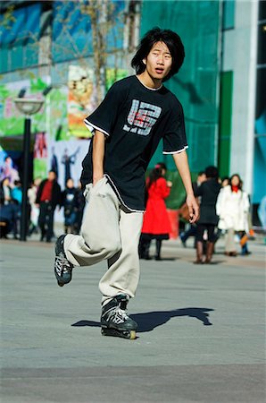 China,Beijing. A Chinese boy roller blading in Wanfujing shopping street. Stock Photo - Rights-Managed, Code: 862-03351367