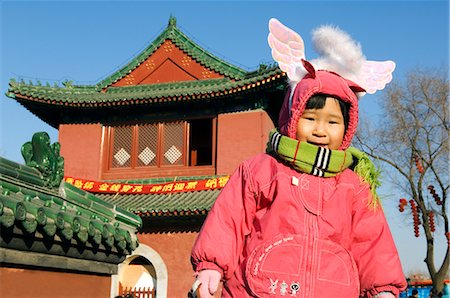 China,Beijing. Chinese New Year Spring Festival - a cute girl in pink clothes with angel wings and halo at Ditan Park temple fair. Stock Photo - Rights-Managed, Code: 862-03351556