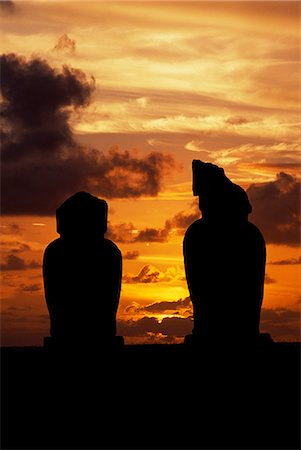 simsearch:862-03360742,k - The sun sets over the Pacific silhouetting two of the moais on the platform of Ahu Vai Uri at the ceremonial centre of Tahai. Tahai is just a short walk from Easter Island's main settlement,Hanga Roa on the west coast of the island,backed by the Pacific Ocean. Stock Photo - Rights-Managed, Code: 862-03352100