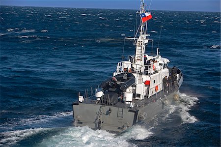 dingy - Chile,Tierra del Fuego. A Chilean Navy Pilot Boat meets an Expedition Ship as it enters the Strait of Magellan,the route to the port of Puerto Williams south of the Isla Grande de Tierra del Fuego. Stock Photo - Rights-Managed, Code: 862-03352154