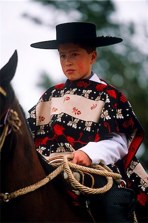 poncho - Chile,Region VI,Parral. A young huaso taking part in a regional Rodeo competition. Stock Photo - Rights-Managed, Code: 862-03352226