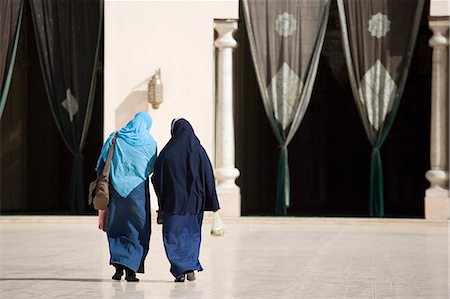 Two muslim women enter the Al-Hikim Mosque in Islamic Cairo. The mosque is one of the oldest in Cairo,having stood since 1010AD and was restored in 1980. Stock Photo - Rights-Managed, Code: 862-03352821