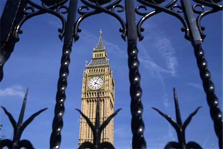 London's famous Clock Tower,Big Ben,is framed by the gates of the Palace of Westminster. Big Ben's name actually comes from the 13 tonne bell hanging inside the tower and named after its commissioner,Benjamin Hall Stock Photo - Rights-Managed, Code: 862-03353314