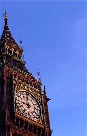 The ornate face of London's iconic Clock Tower known as Big Ben. The tower actually gained its nickname from the 13 tonne bell hanging inside its structure which was named after commissioner Benjamin Hall. Stock Photo - Rights-Managed, Code: 862-03353318
