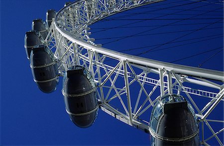 revolve - The British Airways London Eye,simply known as the Eye,on the River Thames in central London. The London Eye,at 135 metres tall is the world's largest sightseeing wheel and was builts as one of the city's Millenium projects Stock Photo - Rights-Managed, Code: 862-03353310
