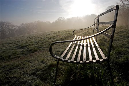 England,Shropshire,Ludlow. Wrought Iron benches on Whitcliffe Common on a misty Spring morning - providing lovely views of the castle and town of Ludlow. Stock Photo - Rights-Managed, Code: 862-03353689