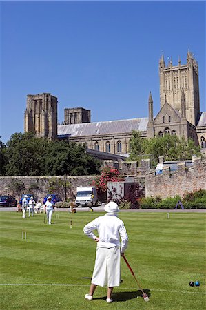 England,Somerset,Wells. With Wells Cathedral in the background a game of summer croquet takes place on the lawns in front of the Bishops Palace Stock Photo - Rights-Managed, Code: 862-03353800