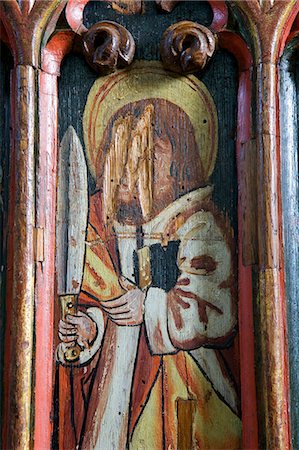 England,Devon,Dartmoor National Park,Manaton. The 15th century St Winifreds Church with its Tudar Rose and Fleur de Lis decorations rod screen,commemorating many Christian saints and martyrs. When the Reformation came to England towards the middle of the sixteenth century a decree from the Privy Council in 1548 ordered all superstitious images to be taken down or defaced. Stock Photo - Rights-Managed, Code: 862-03353816